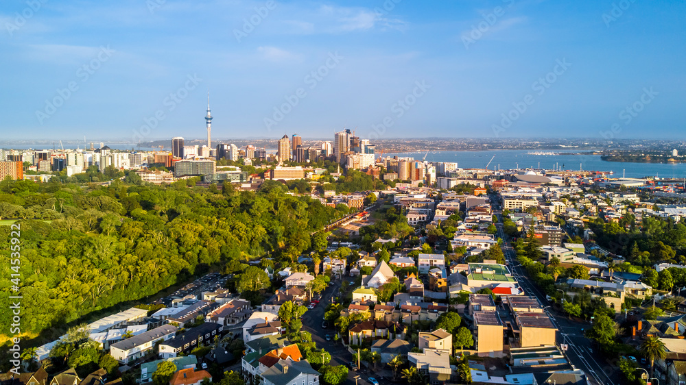 Aerial view of the city center with the beautiful harbor in the background and a quiet suburb in the foreground. Auckland New Zealand.