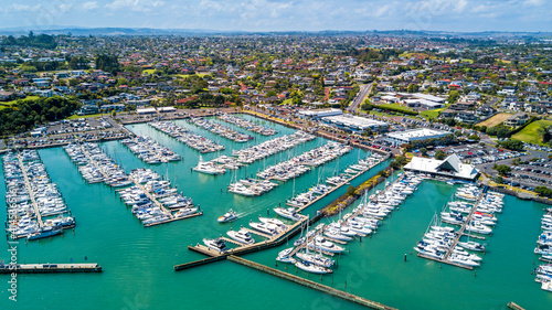 Aerial view on a marina with a residential suburb in the background. Auckland, New Zealand.
