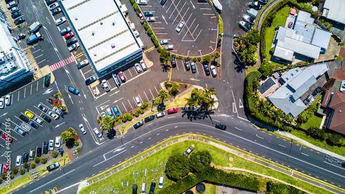 Aerial view on a busy plaza with car parking and residential houses nearby. Auckland, New Zealand.