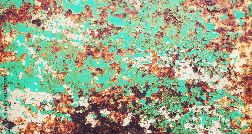 A textured metal surface, with rough rust destroying the outer layer. Colors: green, orange.
