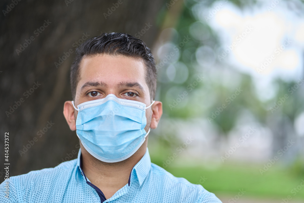 portrait of a handsome young ecuadorian wearing facemask in a park in guayaquil portrait of a handsome young ecuadorian wearing facemask in a park in guayaquil