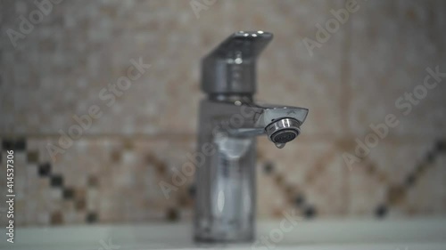 dripping faucet in the bathroom. slow motion