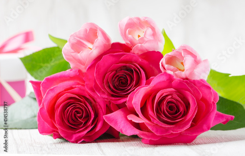 tulips and roses on a table and a light background