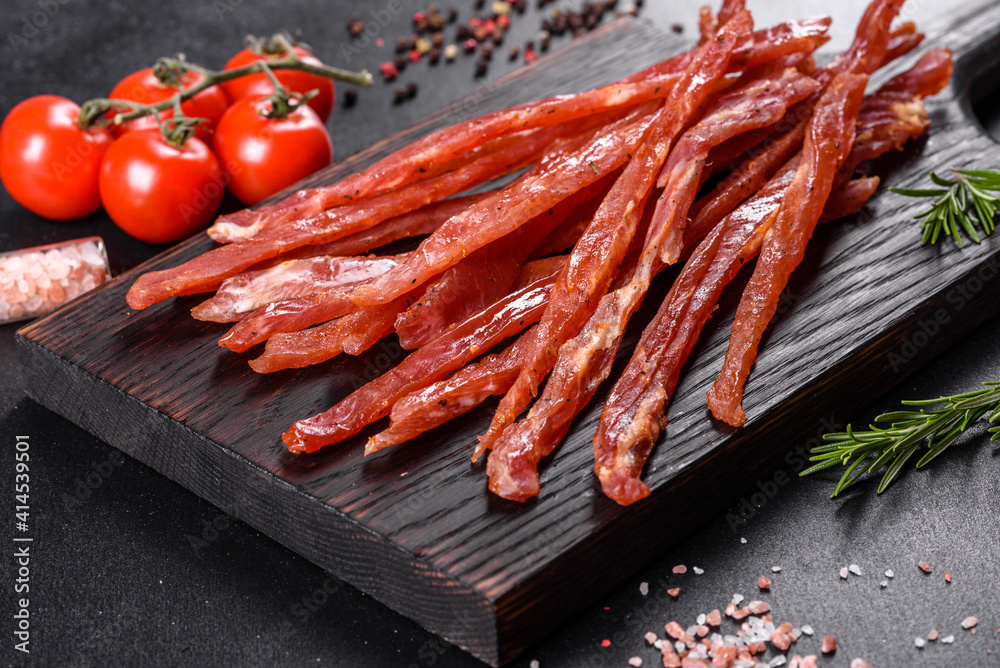 Tasty hearty meat salted and dried with pieces of spices and herbs Tasty hearty meat salted and dried with pieces of spices and herbs