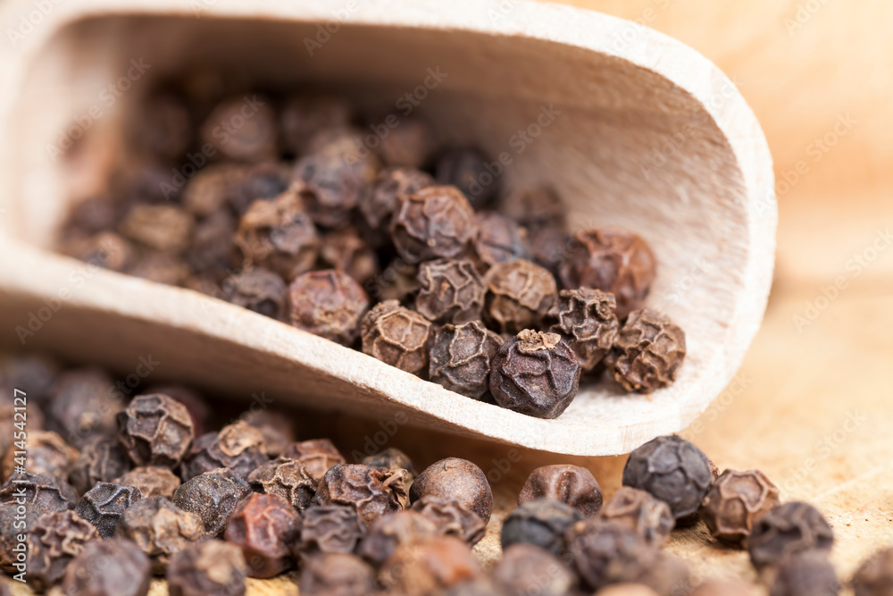 black peas pepper on an old wooden table black peas pepper on an old wooden table