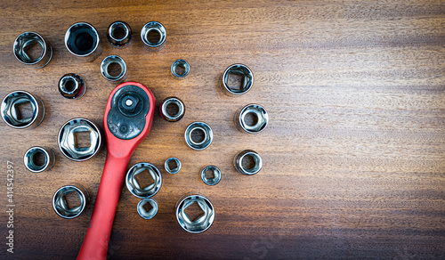 Set of hexagonal heads for ratchet key on brown wood texture background photo