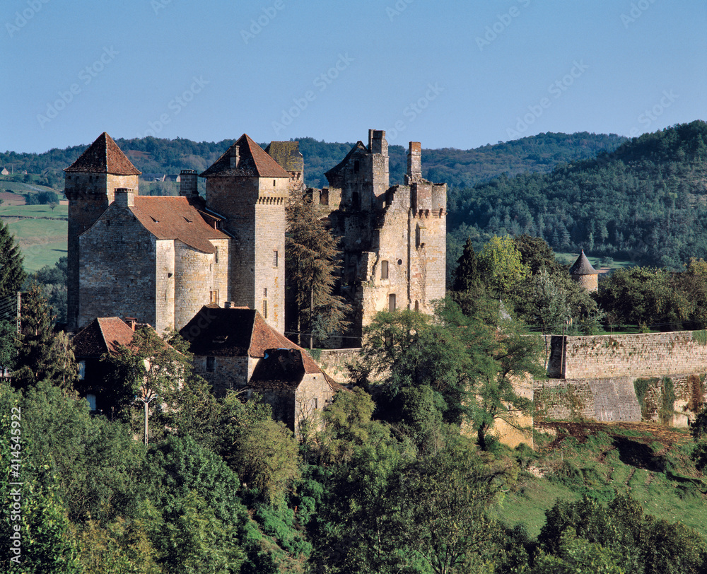 Europe, France, Curemonte. The towers of Curemonte Castle catch the late afternoon light in the Limousin Region of France.