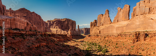 Panorama shot of red sandstone rocks, monoliths and mountains in Park Avenue in arches national park in utah, america