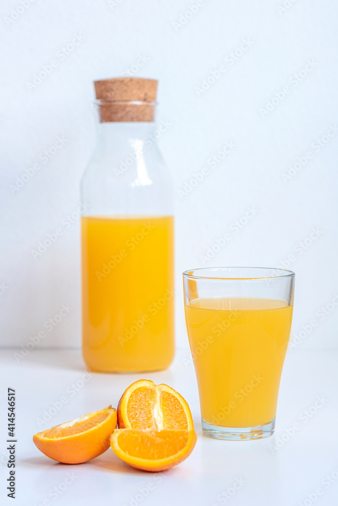 Orange juice in a glass and fruits on white background, close up Orange juice in a glass and fruits on white background, close up