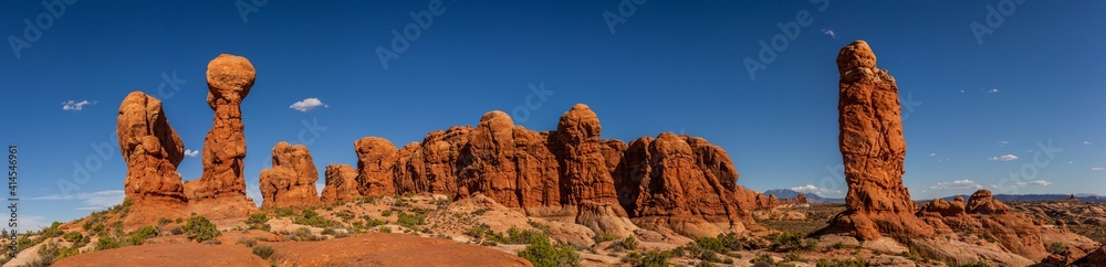 Panorama shot of three red sandstone monoliths and sandstone hill in background in arches national park in utah, america Panorama shot of three red sandstone monoliths and sandstone hill in background in arches national park in utah, america