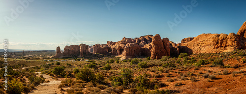 Panorama shot of red sandstone monoliths, arches and mountains windows in arches national park in Utha, America