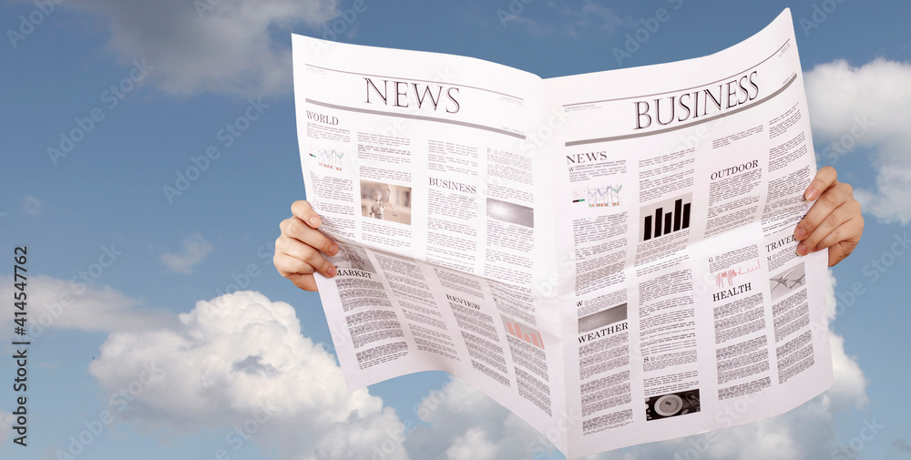 Naklejka premium hand holding newspaper