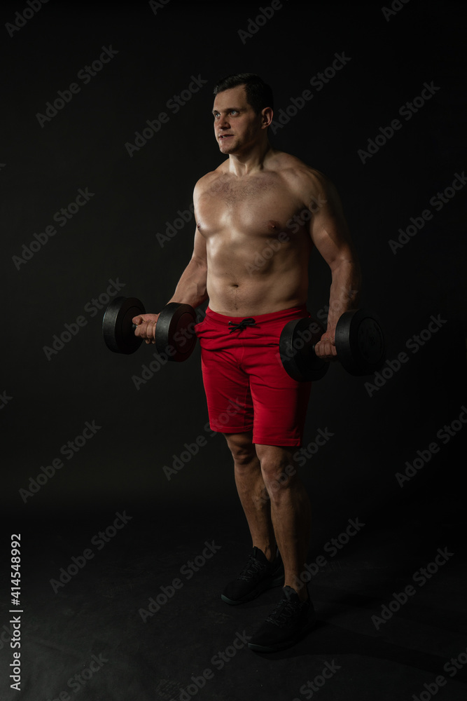 Fitness man presses dumbbells in red panties business caucasian smart, torso studio boy, success lonely background black bodybuilder Fitness man presses dumbbells in red panties business caucasian smart, torso studio boy, success lonely background black bodybuilder