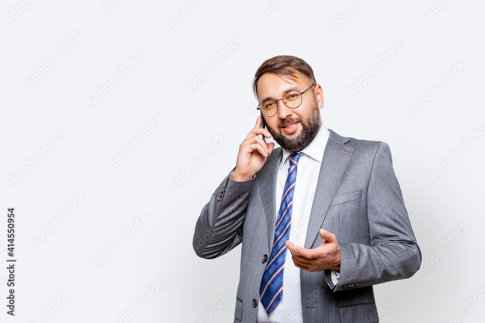 Image of handsome business man with beard indoors talking by mobile phone Image of handsome business man with beard indoors talking by mobile phone