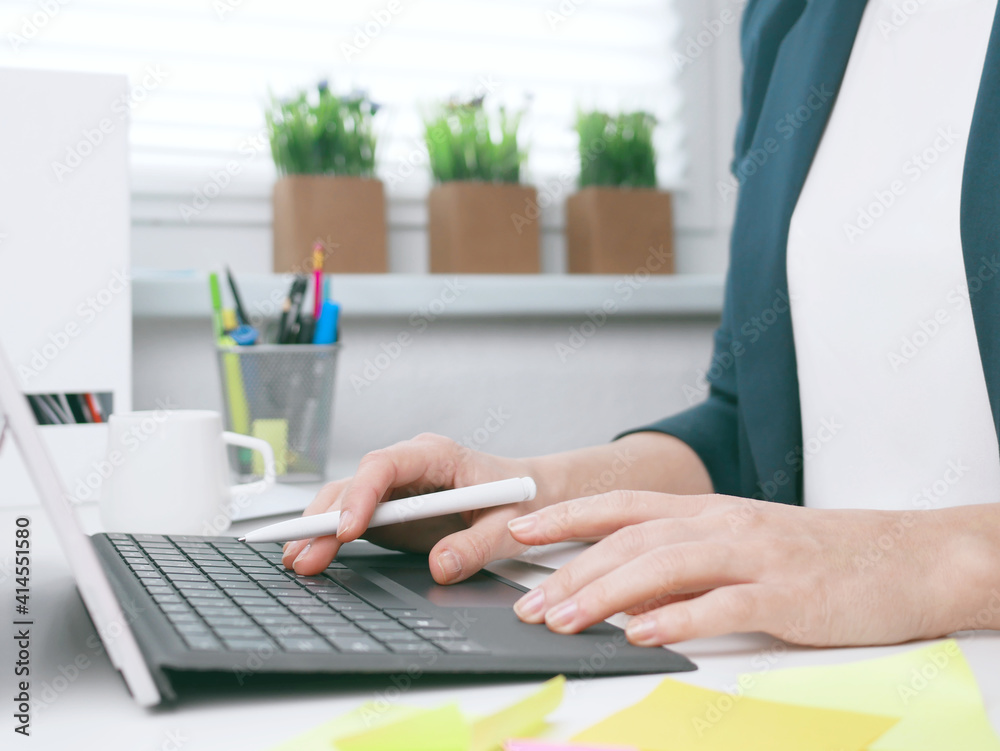 young woman typing on the laptop keyboard. Home office, online business marketing or learning concept. Online shopping, booking and banking background with copy space