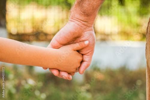 A the hands of a parent and child in the park © Kostia