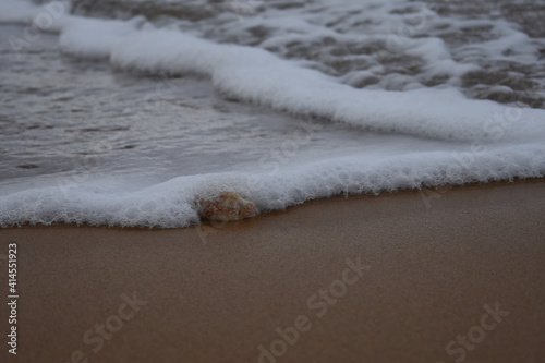 waves on beach layered with rock
