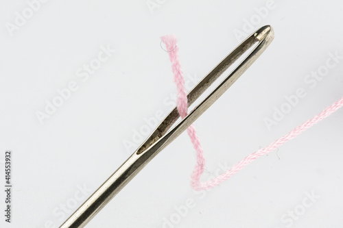 darning needle eye and thread