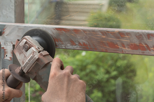 Person With Angle Grinder Grinds Metal
