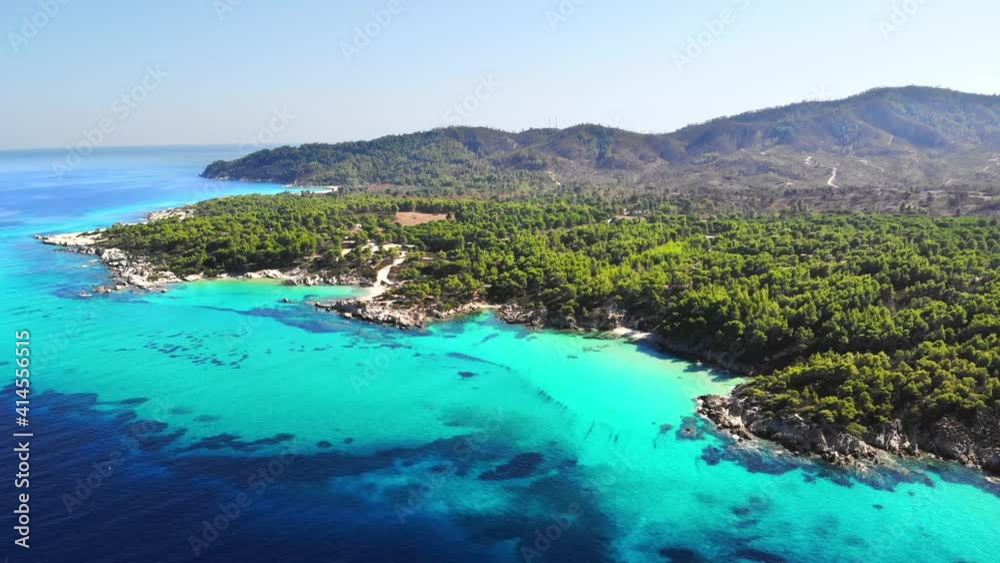 Aerial drone view of the Aegean sea rocky coast with blue transparent water, multiple greenery, hills. Greece Aerial drone view of the Aegean sea rocky coast with blue transparent water, multiple greenery, hills. Greece