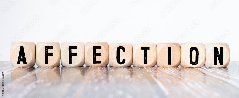 Affection text on wooden block on black texture background Affection text on wooden block on black texture background