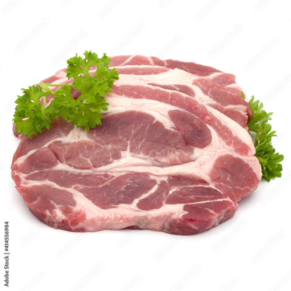 Raw pork neck chop meat with parsley herb leaves garnish isolated on white background cutout Raw pork neck chop meat with parsley herb leaves garnish isolated on white background cutout