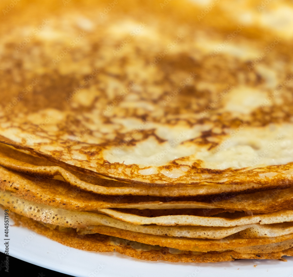a stack of pancakes on a white plate a stack of pancakes on a white plate