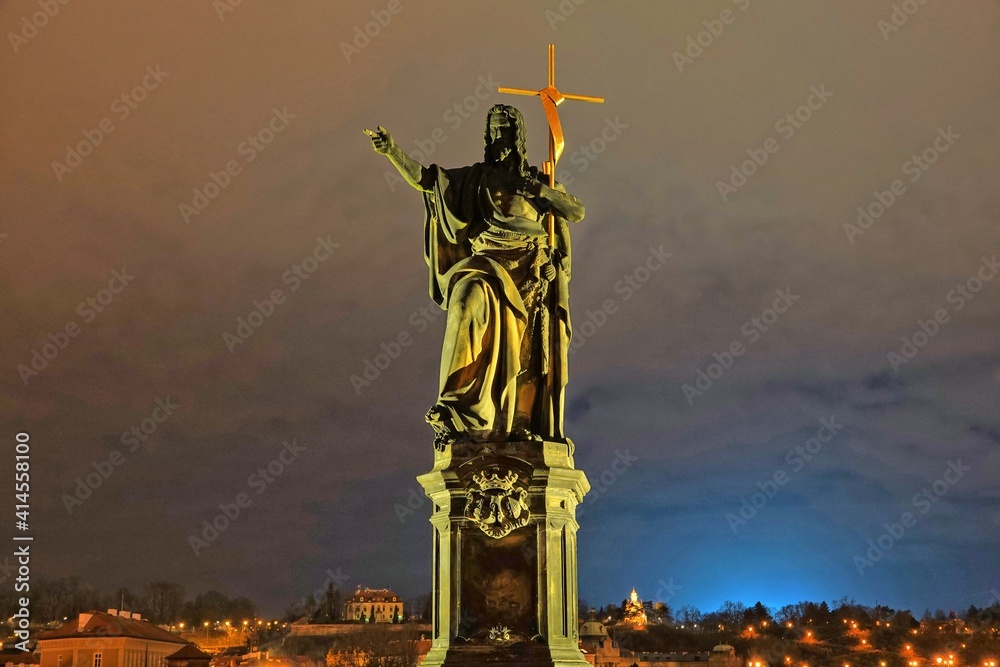 Fototapeta premium Statue of Saint John the Baptist on Charles Bridge in Prague, Czech Republic, by night.