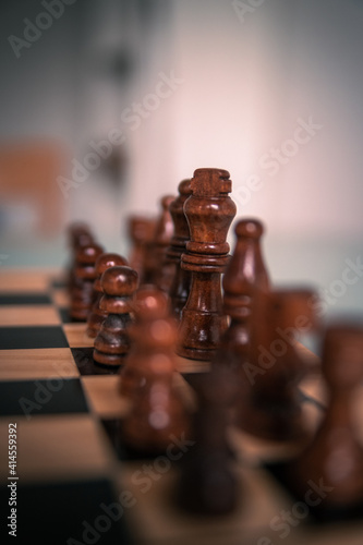 Chess pieces set up ready to play chess game on a wooden board strategy game