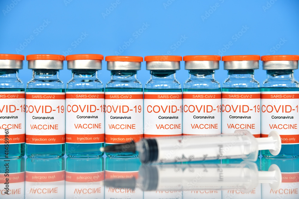Covid-19 vaccine and syringe injection. Covid-19 vaccine and syringe injection.