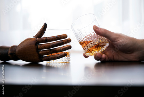 Glass of whisky in hand