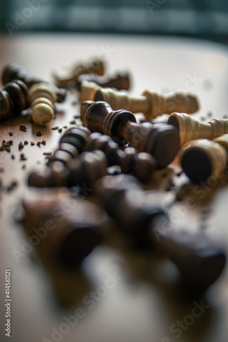 Chess pieces on a wooden table close up photo