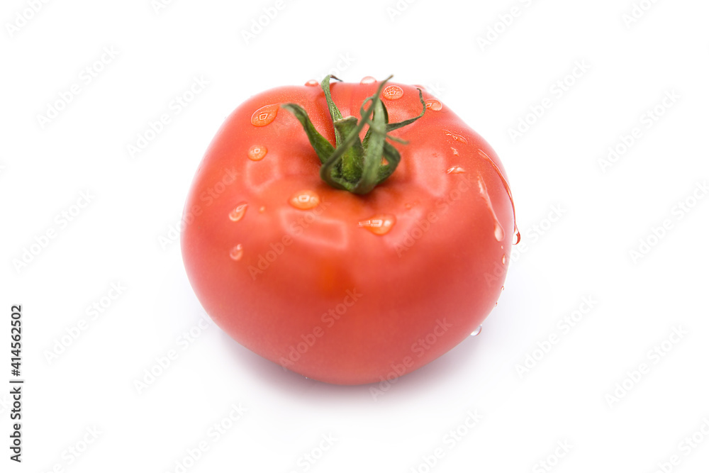 Fresh organic whole tomato in water drops isolated on white background. Fresh organic whole tomato in water drops isolated on white background.