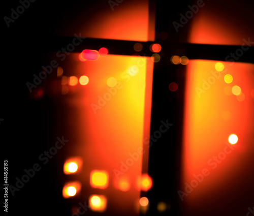 catolic cross silhouette in defocused fiery bokeh photo