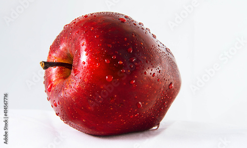 Fresh red apple isolated with drops on white background