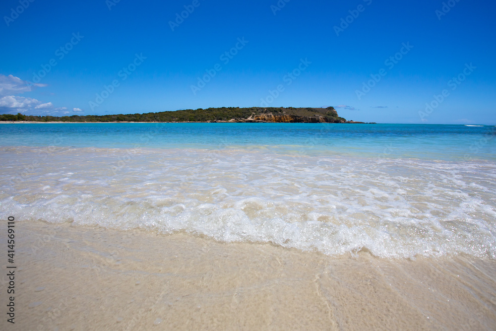 Idyllic beach scene with clear blue water, blue sky and sandy shore seen from Puerto Rico Idyllic beach scene with clear blue water, blue sky and sandy shore seen from Puerto Rico
