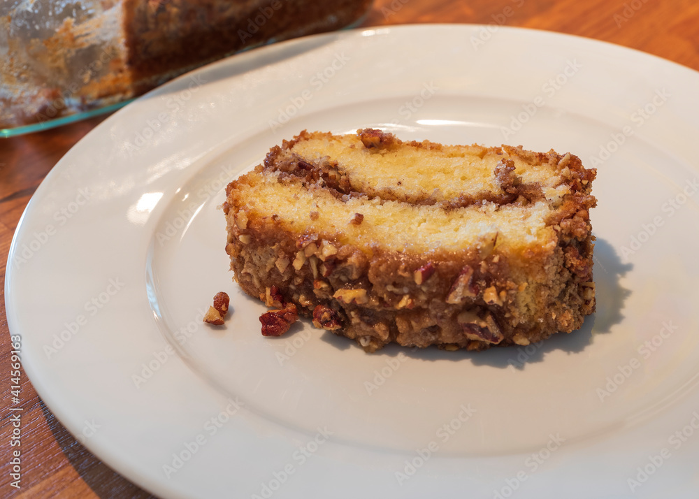 A slice of coffee cake on a white plate A slice of coffee cake on a white plate