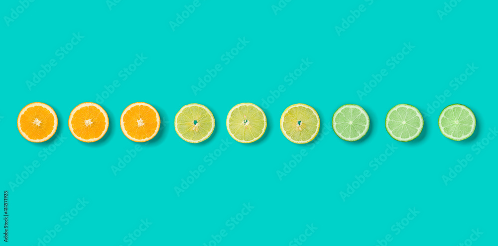 Citrus Fruit pattern on blue background. Orange, Lime, Lemon slices background. Flat lay, top view. Banner, seamless pattern, creative summer food concept. Citrus Fruit pattern on blue background. Orange, Lime, Lemon slices background. Flat lay, top view. Banner, seamless pattern, creative summer food concept.