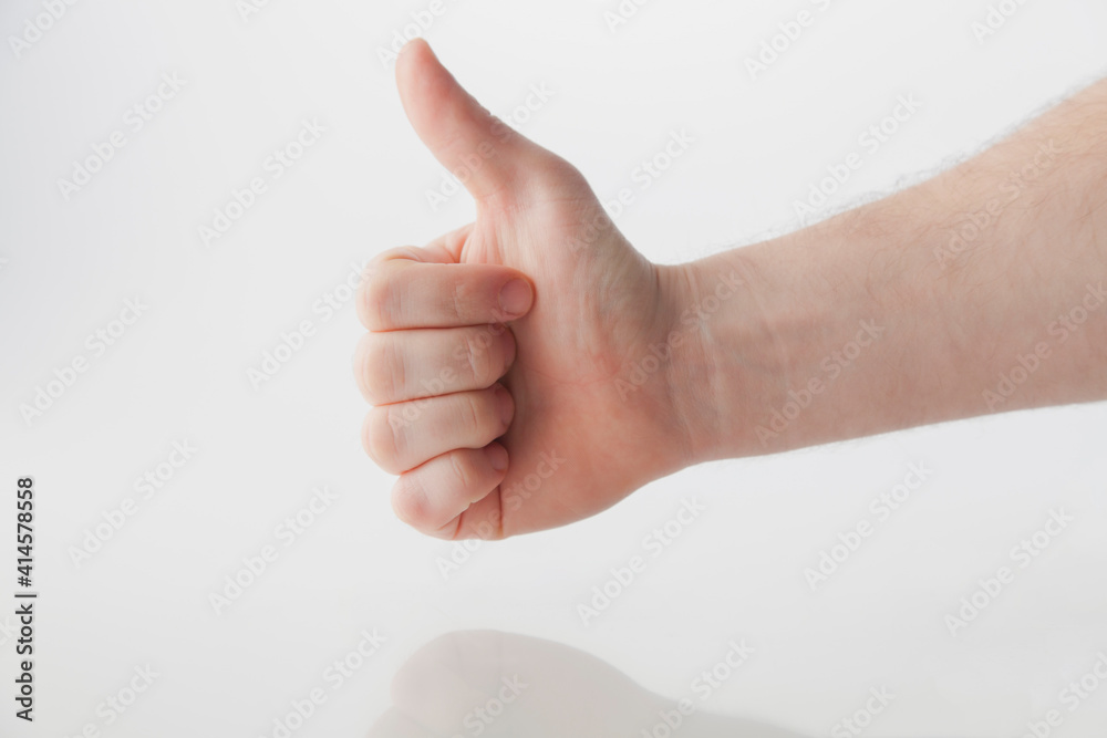 Male Stretched Thumb Against White With Reflection Male Stretched Thumb Against White With Reflection