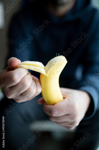 man peeling a banana