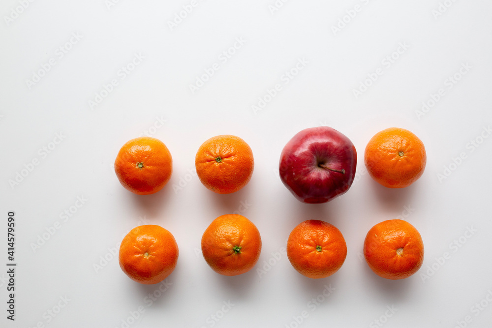 small oranges and one apple