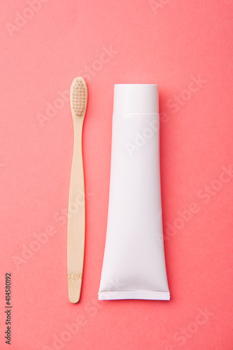 Wooden Toothbrush with Toothpaste on Pink Background Copy Space Flat Lay. Tooth Brushes Scattered on Table. Collection of Elegant Ecological Clear Healthcare Bath Accessory for Clean Teeth
