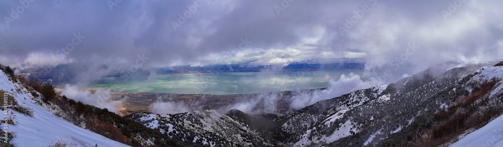 Lake Mountains Peak winter snow mountain hiking trail views via Israel Canyon towards Radio Towers, Utah Lake, Wasatch Front Rocky Mountains, Provo, Utah County. United States.