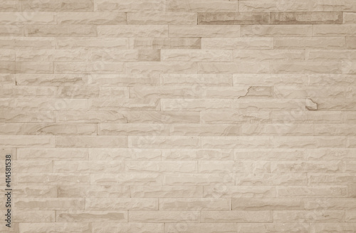 Empty background of wide cream brick wall texture. Beige old brown brick wall concrete or stone textured, wallpaper limestone abstract flooring/Grid uneven interior rock. Home decor design backdrop.