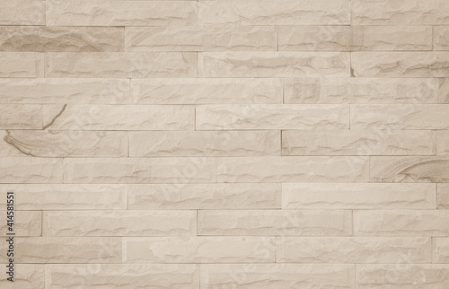 Empty background of wide cream brick wall texture. Beige old brown brick wall concrete or stone textured  wallpaper limestone abstract flooring Grid uneven interior rock. Home decor design backdrop.