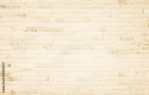 Empty background of wide cream brick wall texture. Beige old brown brick wall concrete or stone textured, wallpaper limestone abstract flooring/Grid uneven interior rock. Home decor design backdrop.