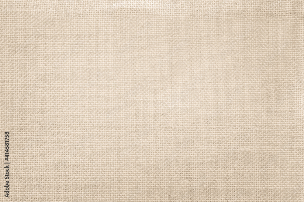 Fototapeta premium Jute hessian sackcloth canvas woven texture pattern background in light beige cream brown color blank empty