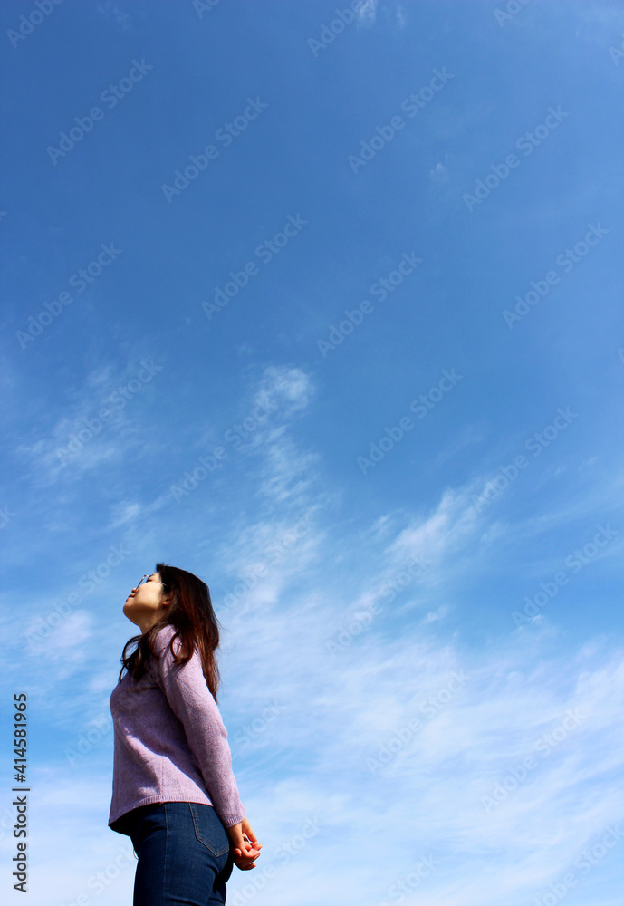 A woman looking at the beautiful blue sky A woman looking at the beautiful blue sky