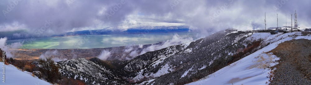 Lake Mountains Peak winter snow mountain hiking trail views via Israel Canyon towards Radio Towers, Utah Lake, Wasatch Front Rocky Mountains, Provo, Utah County. United States.