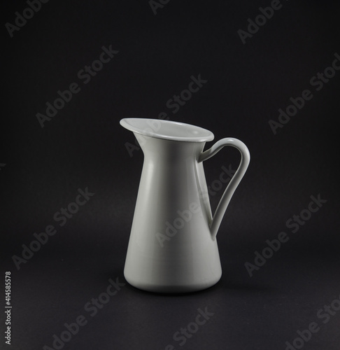 Small metal jar in white tone on black background